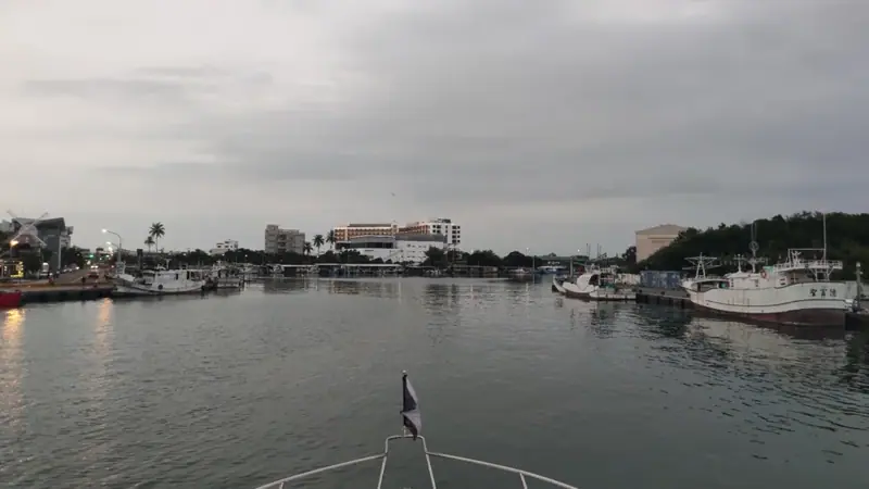 返航時從遊艇船首看港內水道，遠方飯店與兩岸漁船映入眼簾